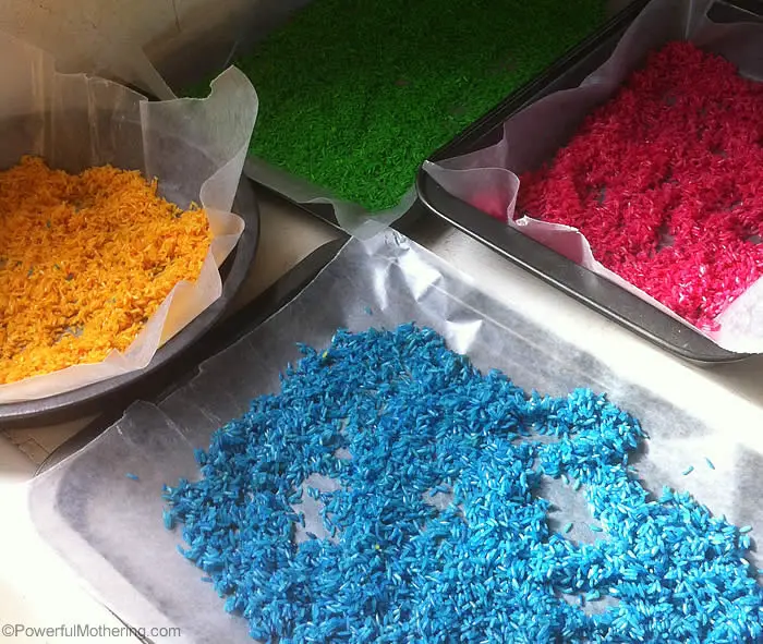 color rice drying on baking sheets with wax paper