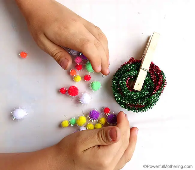 fine motor skills with pom poms pegs and pipe cleaners