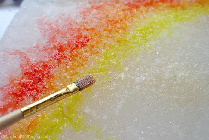 painting rainbow with water colors during melting ice experiment