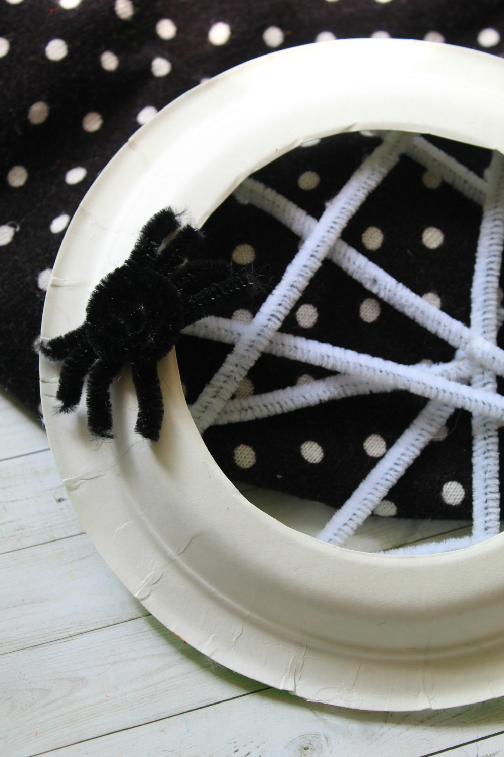 Super fun and spooky Halloween craft for kids. Kids will love to make this paper plate spider web craft! 