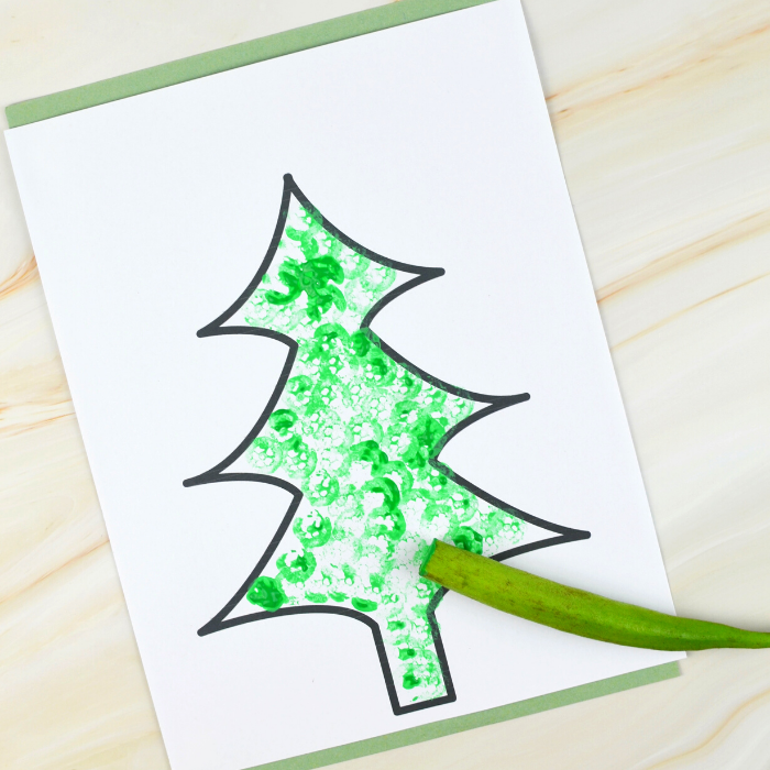 Free printable Christmas Tree templates for children to paint. We are sharing two ways for children to paint these trees, both are so much fun! 